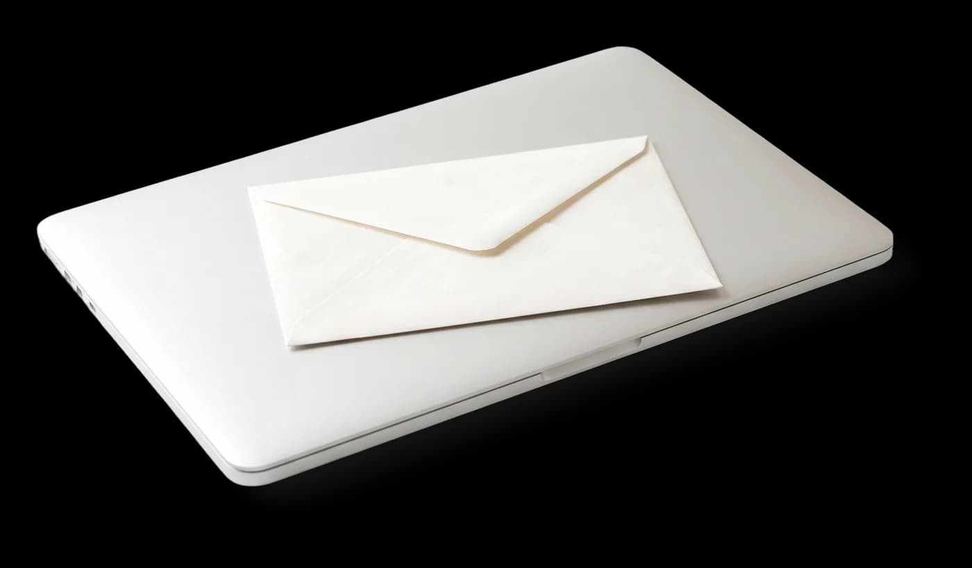 White envelope resting on a closed laptop